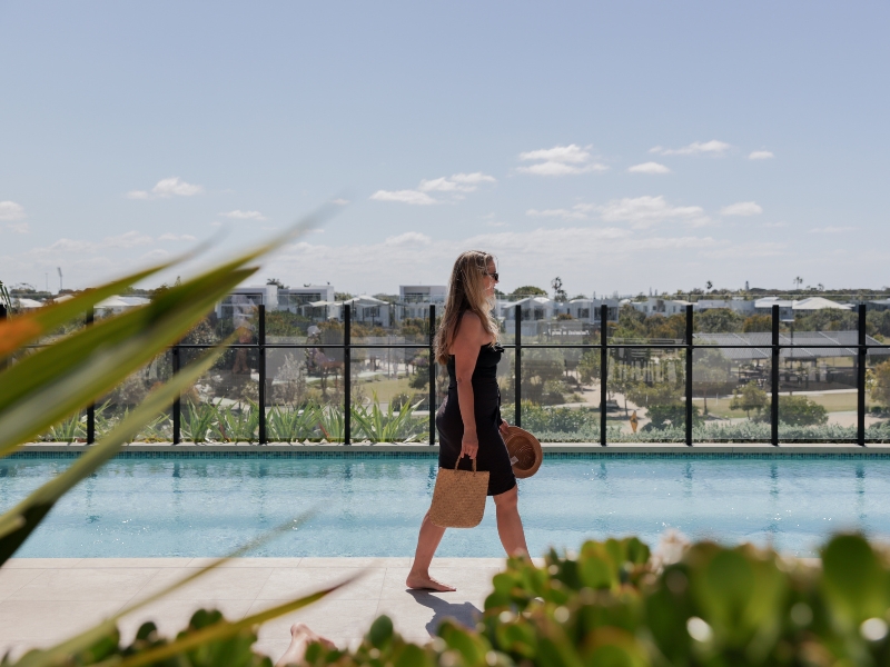 woman walking along pool